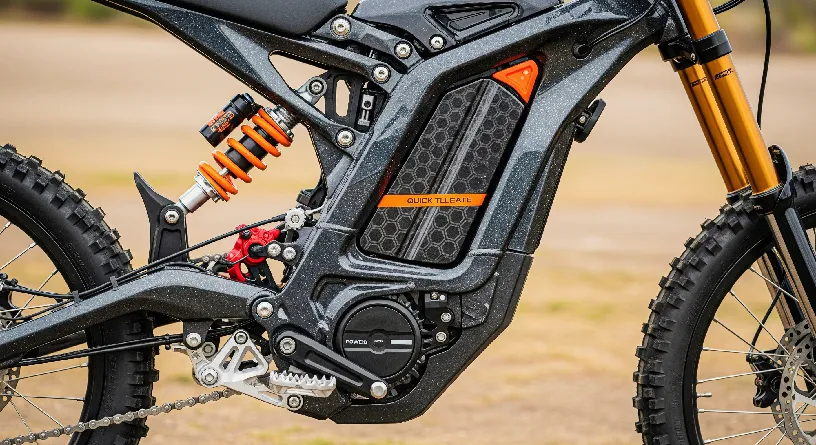 Close-up of GT73 Electric Dirt Bike highlighting frame, wheels, battery, and suspension details with no rider